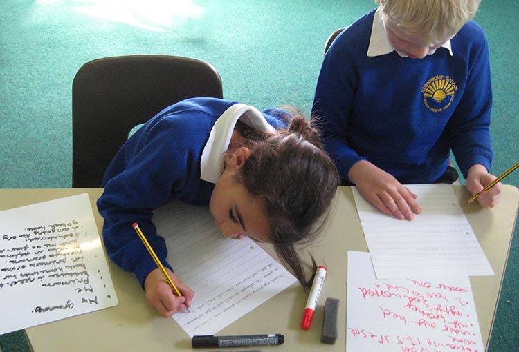 children writing in a Kevin Graal storytelling & writing project for schools